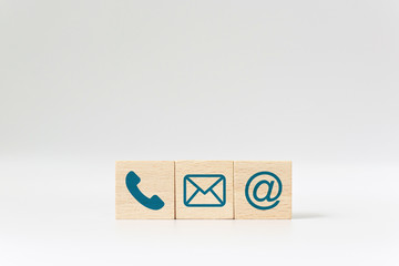 Wooden block cube symbol telephone, email, address. Website page contact us or e-mail marketing...