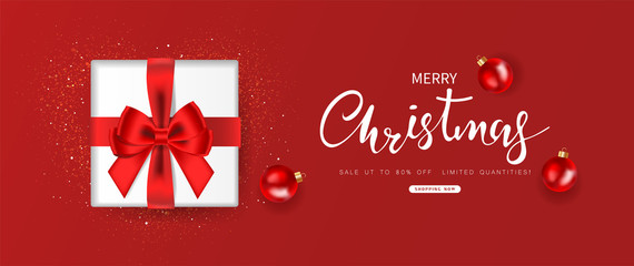 Merry Christmas sale. Gift box decorated with bow and ball design on red background. Top view. Vector illustration.