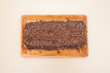 Delicious homemade rolled cake with chocolate icing and grated chocolate. Top view. Horizontal shot.