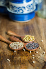 spices in spoons on wooden background
