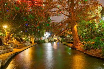 San Antonio River Walk and stone bridge over San Antonio River near Alamo in downtown San Antonio,...