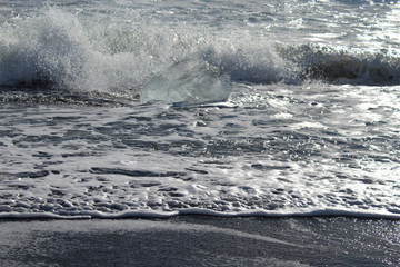Naklejka premium large pieces of iceburg on black sand beach in Iceland