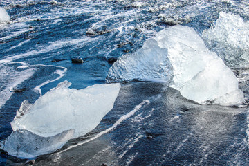Naklejka premium large pieces of iceburg on black sand beach in Iceland