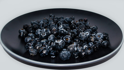Delicious blueberries in black plate
