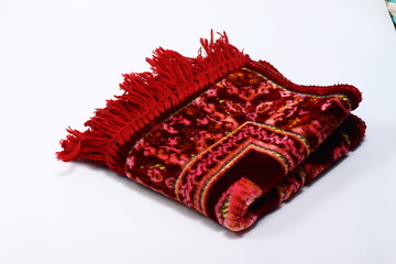 Red praying rug on a white isolated background