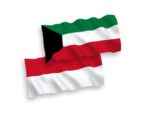 National vector fabric wave flags of Indonesia and Kuwait isolated on white background. 1 to 2 proportion.