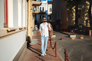 handsome young successful man walks down the street