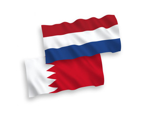 National vector fabric wave flags of Bahrain and Netherlands isolated on white background. 1 to 2 proportion.