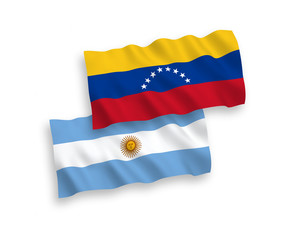 National vector fabric wave flags of Venezuela and Argentina isolated on white background. 1 to 2 proportion.
