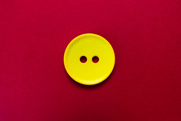  Big yellow button isolated on red background.