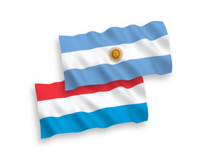 National vector fabric wave flags of Argentina and Luxembourg isolated on white background. 1 to 2 proportion.