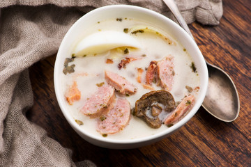 Traditional easter white borscht with eggs and sausage
