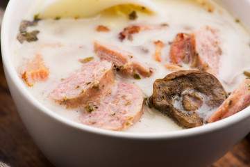 Traditional easter white borscht with eggs and sausage