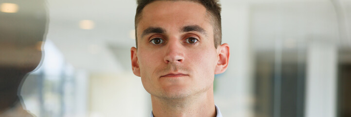 Obraz premium Handsome man in shirt and folder stand