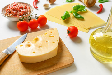 Ingredients for lasagna on white background