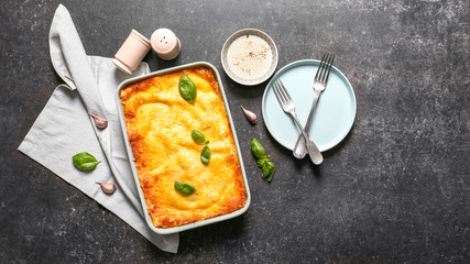 Tasty baked lasagna on dark background