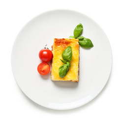 Plate with tasty baked lasagna on white background