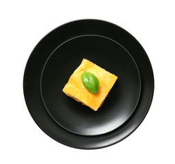 Plate with tasty baked lasagna on white background