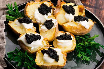 Baked potato with spiced cream cheese and caviar