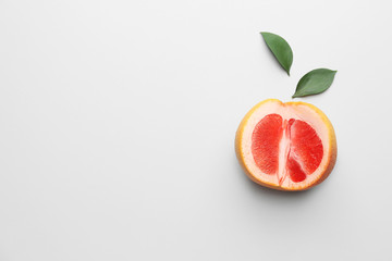 Fresh cut grapefruit on light background
