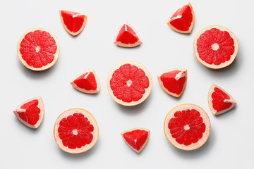 Fresh cut grapefruit on light background