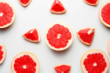 Fresh cut grapefruit on light background