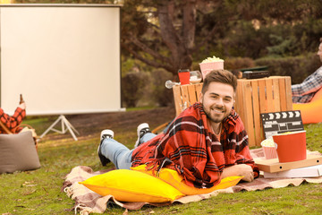 Happy young man in outdoor cinema