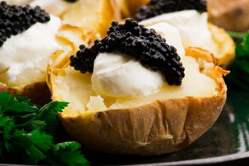 Baked potato with spiced cream cheese and caviar