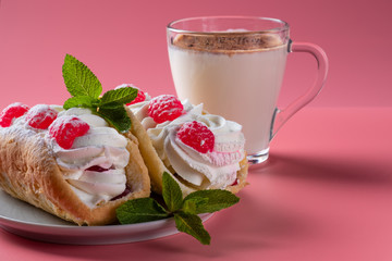 Air cake with raspberries on a saucer. Kefir with cinnamon, fermented drink. Pink background