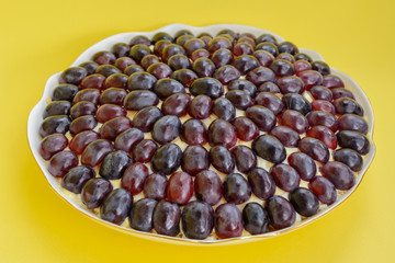 The legendary Tiffany layered salad with grapes, chicken and cheese on the yellow background.