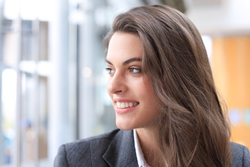 Attractive business woman smiling while standing in the office.