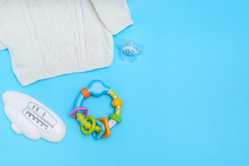 Cute baby accessories on blue background . Copy space Top view Flat lay.