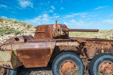 Memorials of WWII: A rusty tank in the bombed dunes near Biville, Normandy, France.