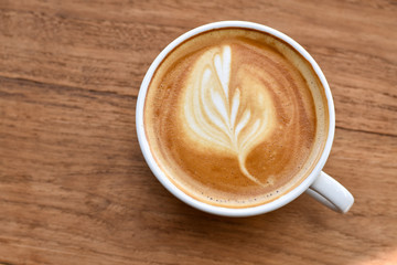 Latte art, Coffee cup on wooden table.