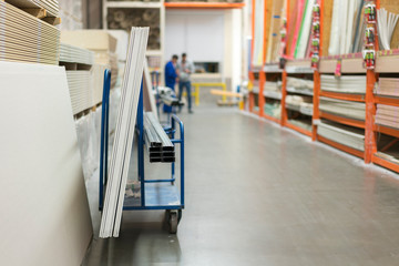 Trolley in a hardware store loaded with construction materials. Repair and construction concept
