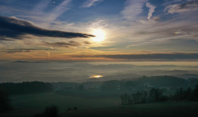 Fototapeta na wymiar Sunrise in winter at the fog sea over the Silbersee