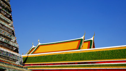 colorful roof clay tiles in Buddhist temple with the clear blue sky.