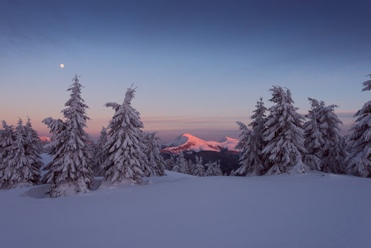Winter Farcau mount in evening light and full moon in the sky