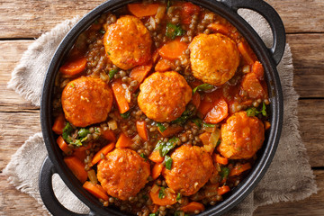 Moroccan meatballs served with lentils in tomato sauce close-up in a pan. Horizontal top view