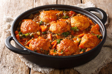 Spicy meatballs with lentil garnish in tomato sauce close-up in a pan. horizontal