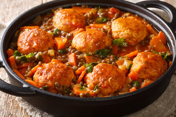 Moroccan meatballs served with lentils in tomato sauce close-up in a pan. horizontal