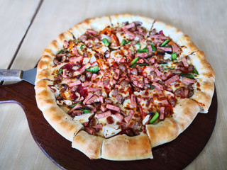Fresh pizza on a wooden table