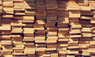 wooden background from boards stacked in piles.
