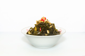 Shredded seaweed salad served in a white China bowl