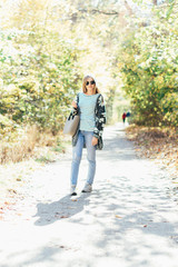 Portrait of young beautiful happy woman, autumn outdoors