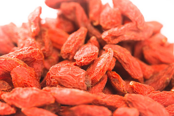 Spread out goji berries on a white background.