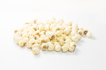 A pile of lotus seeds on a white background.