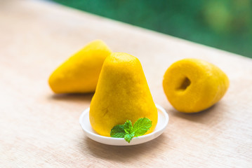 Wugou head on the outdoor board, a green mint leaf embellished, faded green background.