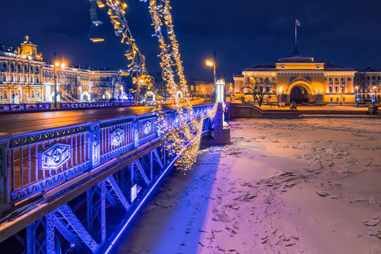 Saint Petersburg. Russia. Admiralty. Panorama of St. Petersburg. Excursions in the winter city. Ice in the Neva. Bridge. Night promenade. Lights of the night city. Winter holidays in Russia.