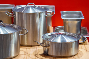 Pans. Hot dishes. Pans for restaurants from stainless steel. Inventory for the kitchen cafe. Pans of different sizes. Clean dishes. Container for restaurant cooks. Concept - Catering Enterprise